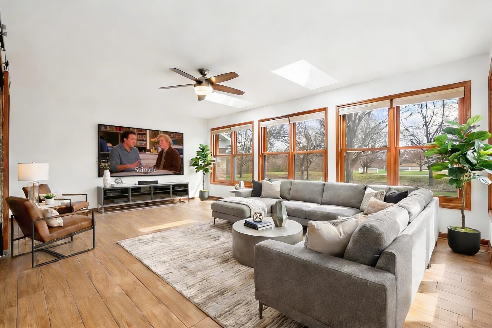 225 Fairway Drive Prospect Heights, IL 60070 - Photo 21 of 57 a living room with furniture a large window and a flat screen tv