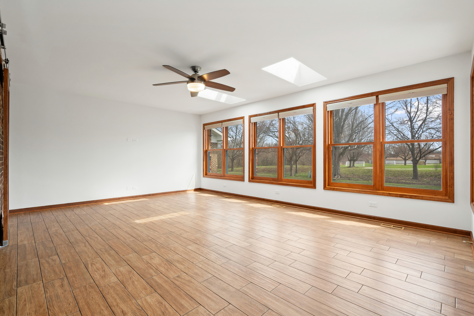 225 Fairway Drive Prospect Heights, IL 60070 - Photo 22 of 57 a view of room with wooden floor and fan