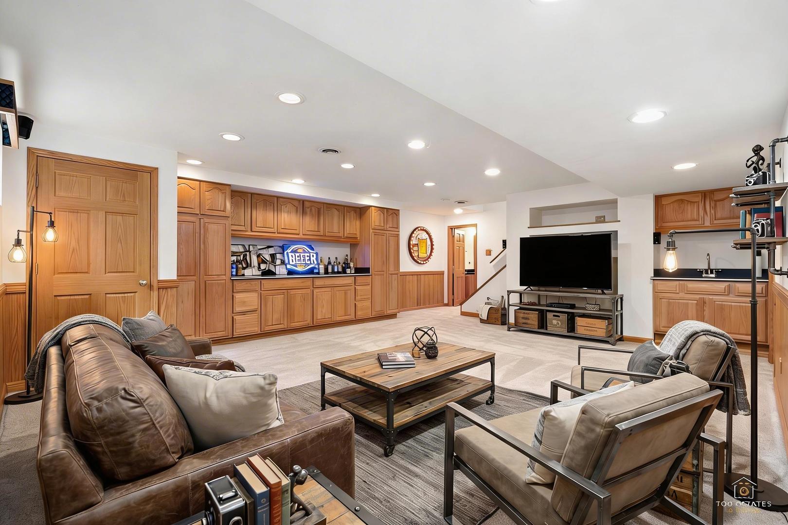 225 Fairway Drive Prospect Heights, IL 60070 - Photo 42 of 57 a living room with furniture kitchen view and a flat screen tv
