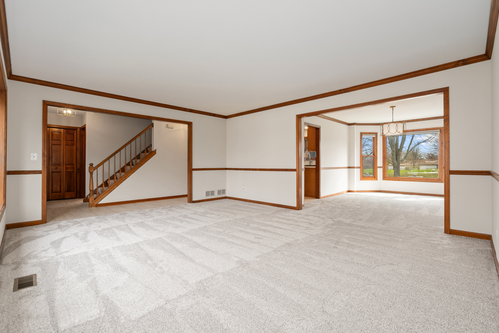 225 Fairway Drive Prospect Heights, IL 60070 - Photo 10 of 57 a view of an empty room with wooden floor and a ceiling fan