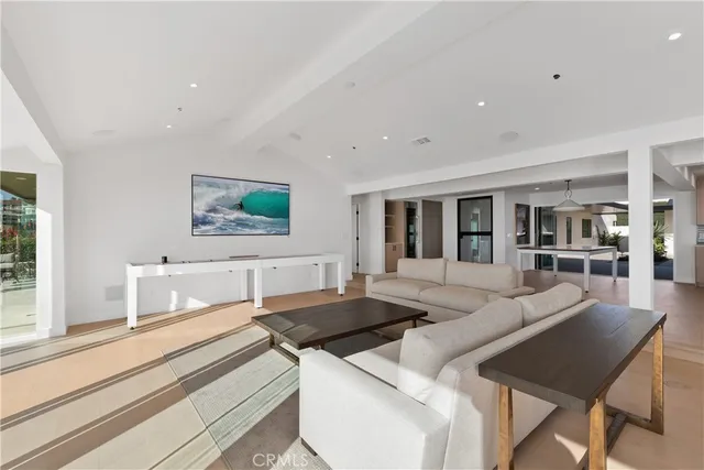 a large white kitchen with stainless steel appliances granite countertop a stove and a refrigerator with white cabinets