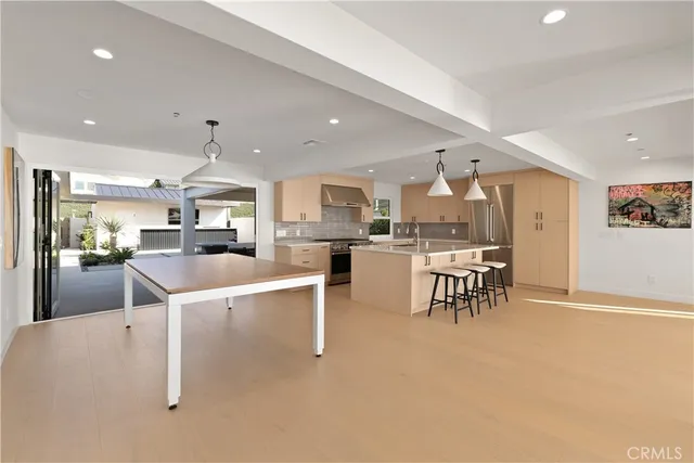 a kitchen with granite countertop a sink a stove and refrigerator