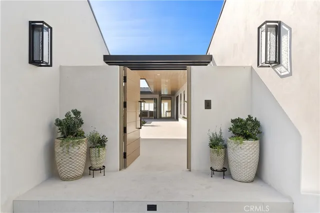 a view of a patio with table and chairs and floor to ceiling window
