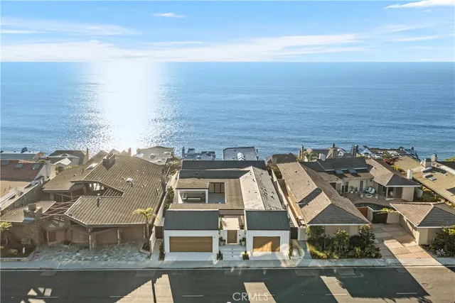 a view of a house with a yard and lake view