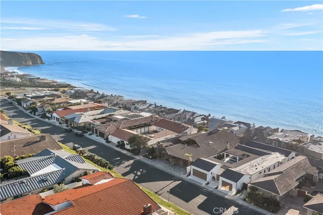 a large white kitchen with a large window