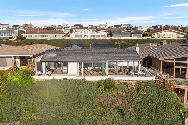 a view of a sign board with flower plants and wooden fence