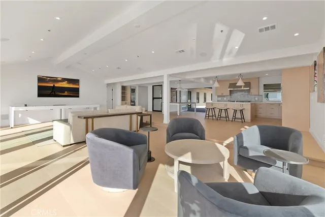 a living room with furniture and view of kitchen