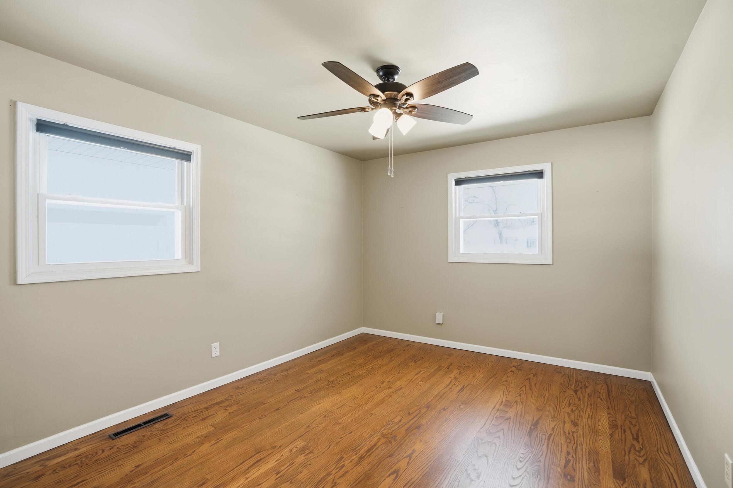44 Timrick Drive Munster, IN 46321 - Photo 11 of 27 a view of an empty room with wooden floor and a window