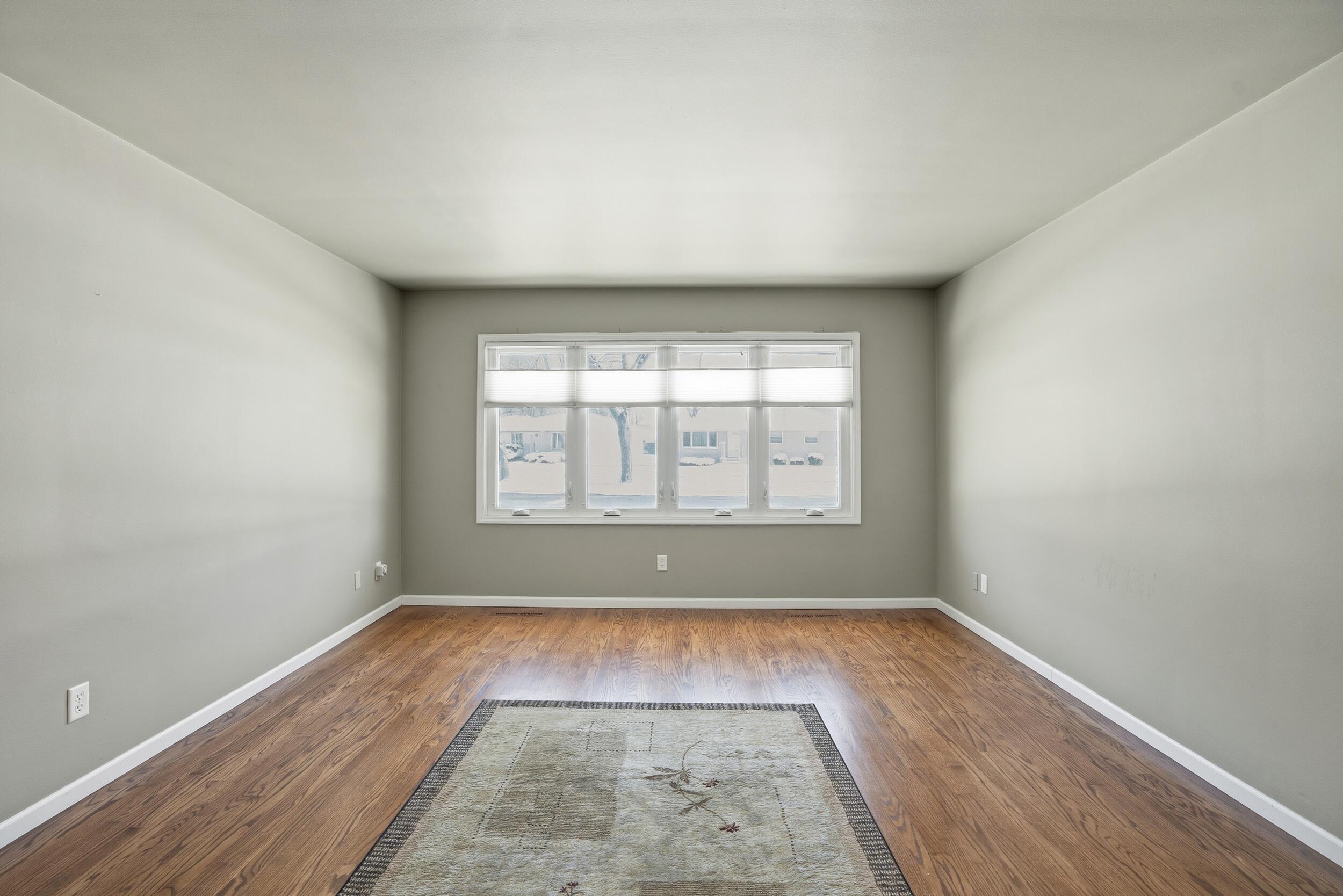 44 Timrick Drive Munster, IN 46321 - Photo 5 of 27 an empty room with wooden floor and windows