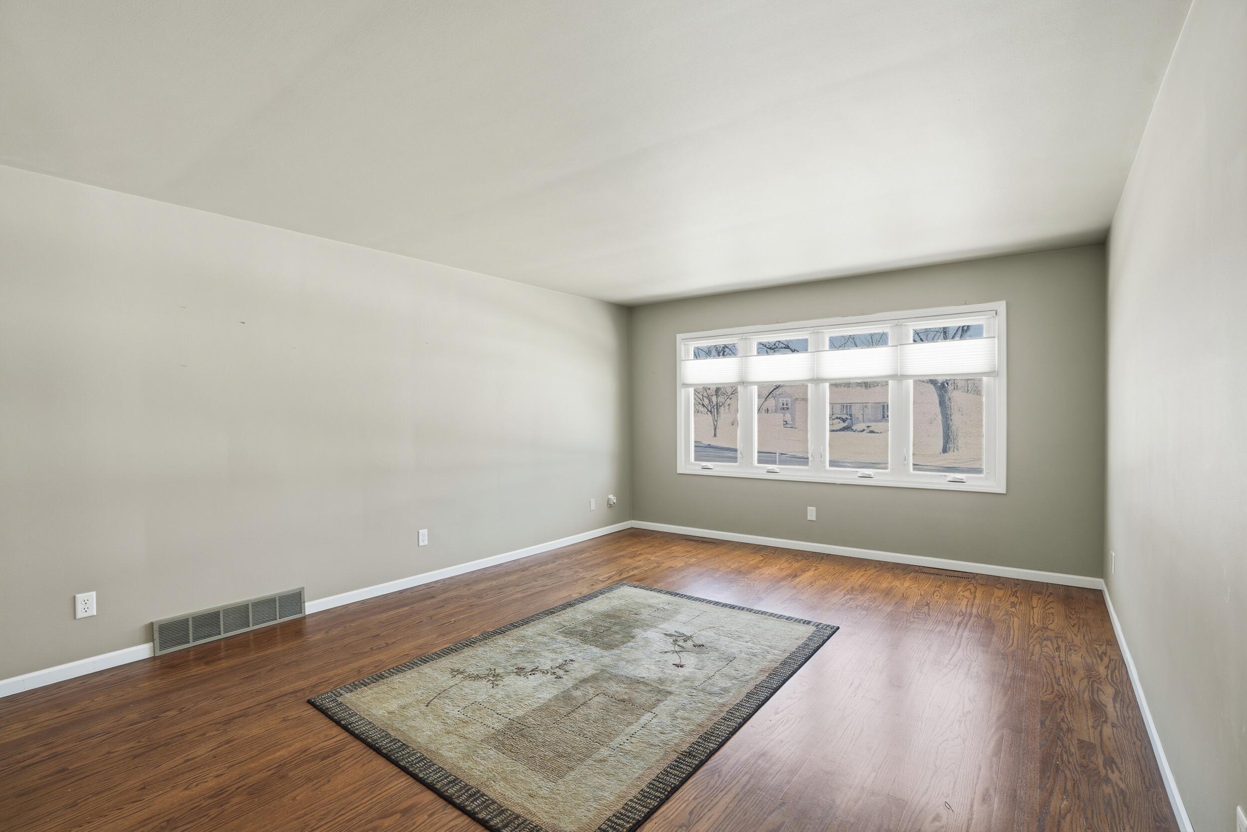 44 Timrick Drive Munster, IN 46321 - Photo 6 of 27 wooden floor in an empty room with a window