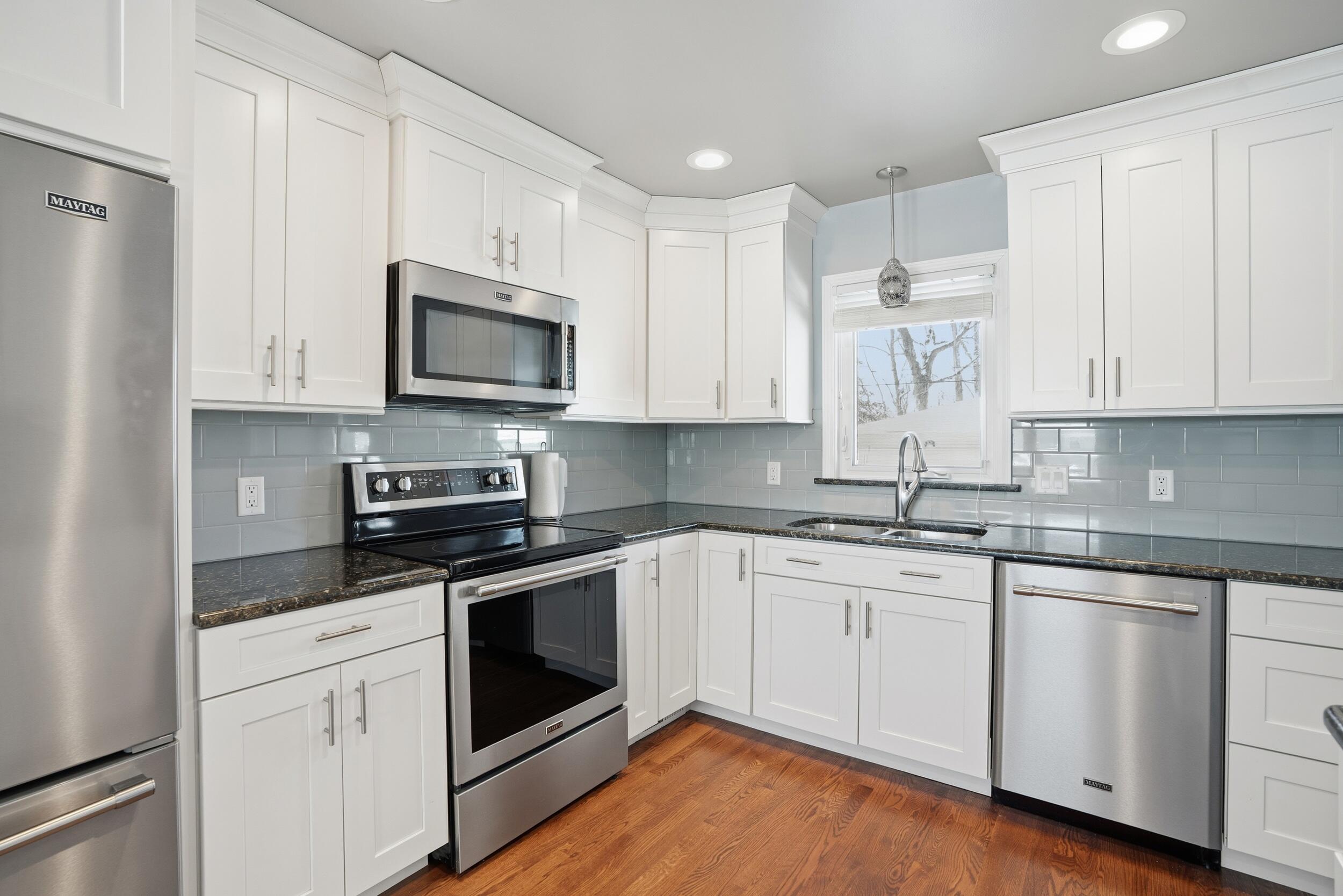 44 Timrick Drive Munster, IN 46321 - Photo 8 of 27 a kitchen with cabinets stainless steel appliances a sink and wooden floor