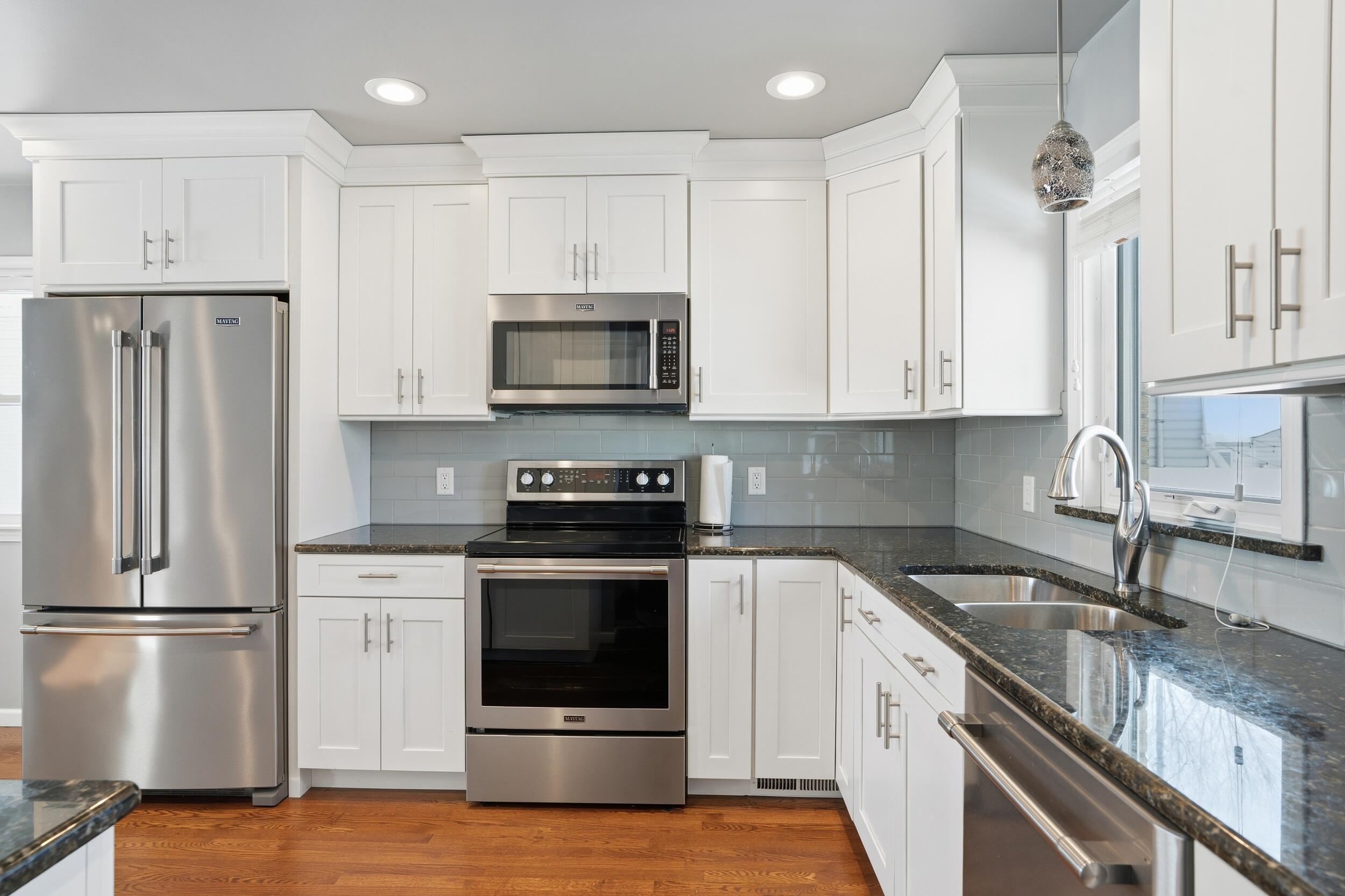 44 Timrick Drive Munster, IN 46321 - Photo 9 of 27 a kitchen with stainless steel appliances granite countertop a stove a refrigerator and a sink