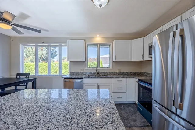 a view of empty room with wooden floor and fireplace
