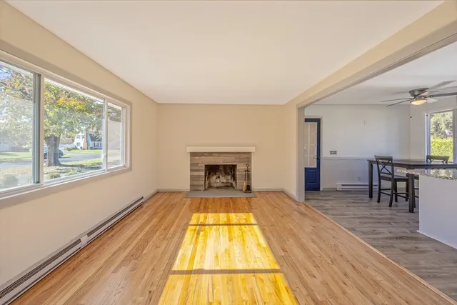 a view of a kitchen with wooden floor and electronic appliances