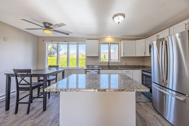a view of empty room with wooden floor and fireplace