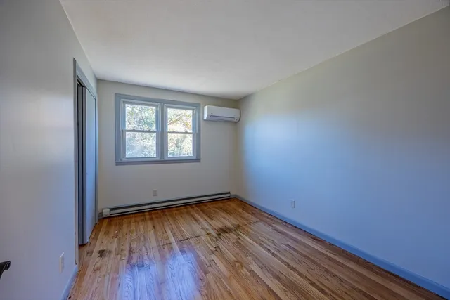a view of a livingroom with wooden floor and stairs