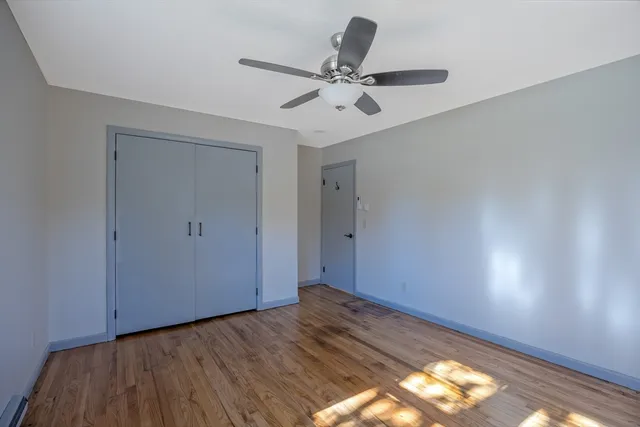 a view of a room with wooden floor and natural light