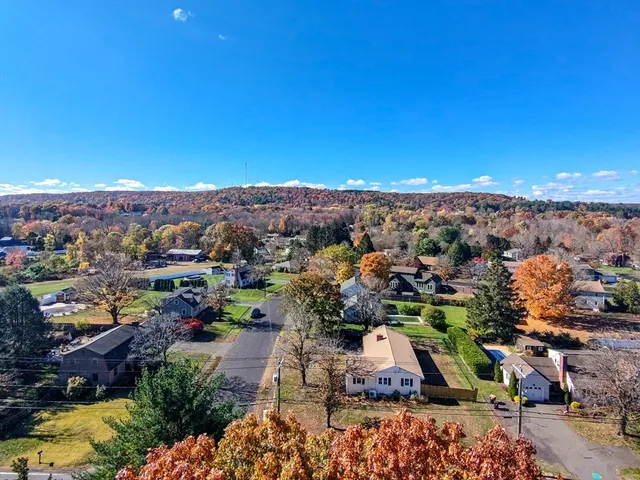 a view of a white house with a yard