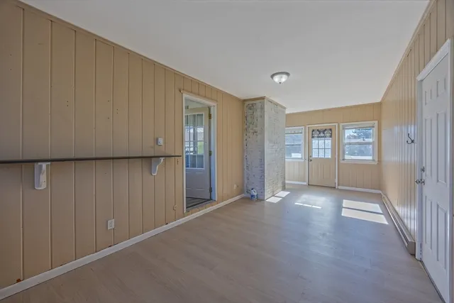 a kitchen with a table chairs refrigerator and microwave
