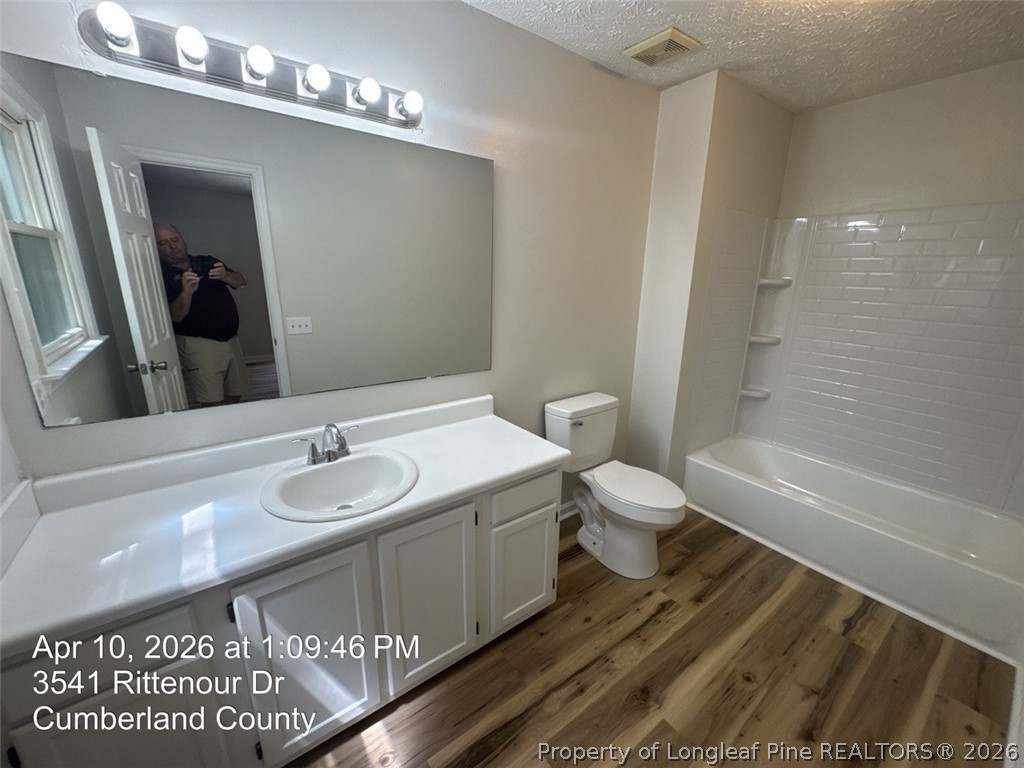 3541 Rittenour Drive Hope Mills, NC 28348 - Photo 11 of 19 a bathroom with a granite countertop sink toilet a large mirror a bathtub and shower