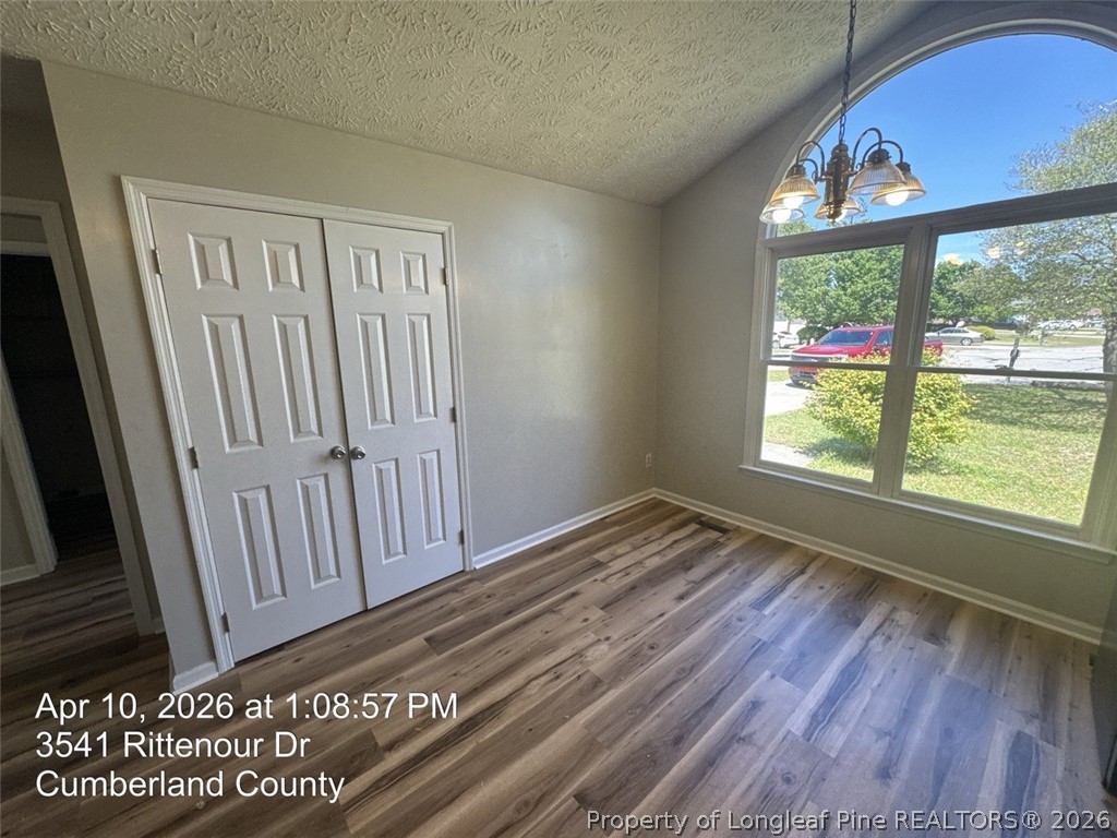 3541 Rittenour Drive Hope Mills, NC 28348 - Photo 8 of 19 a view of an empty room with wooden floor and a window