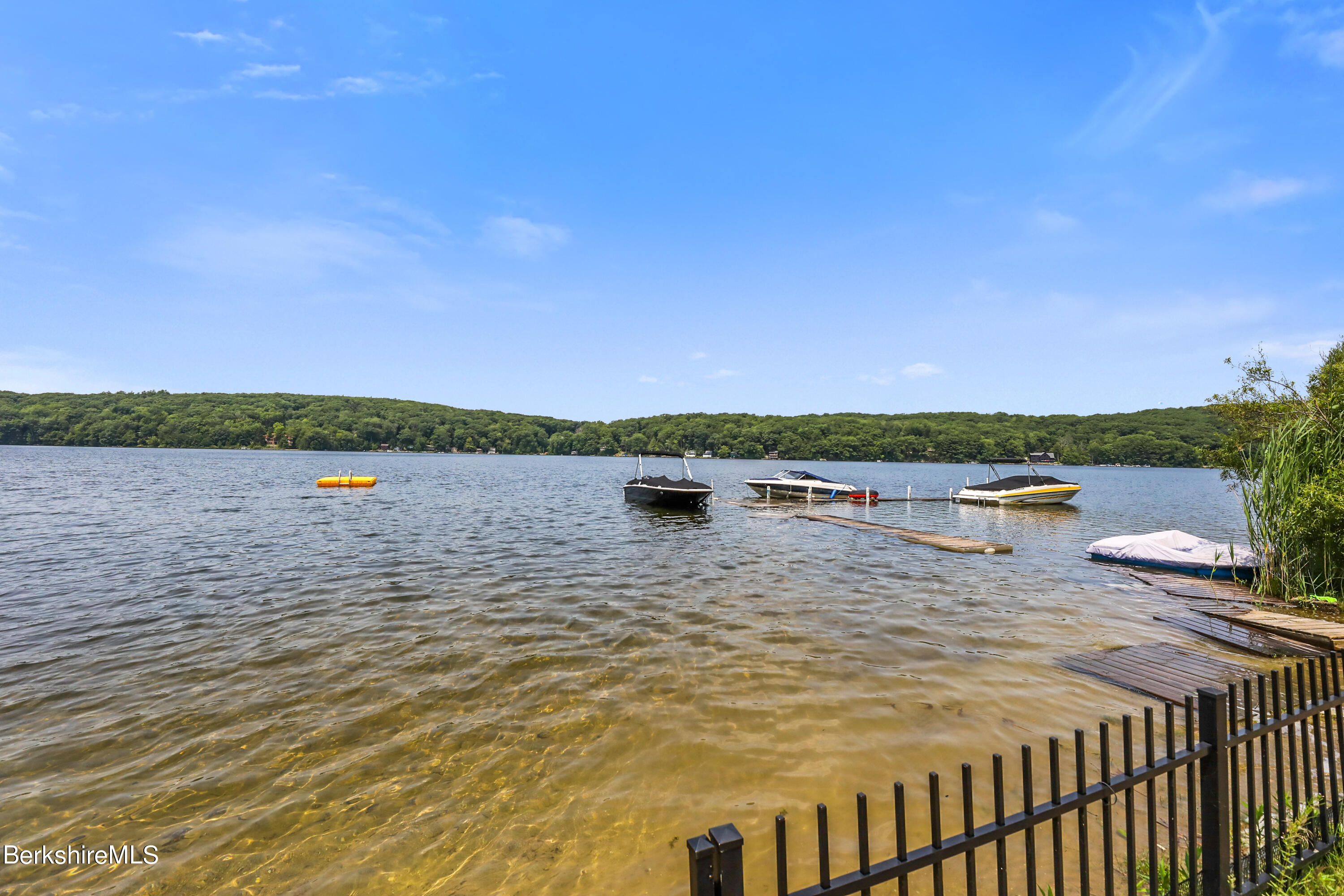 71 Goose Pond Road Tyringham, MA 01238 - Photo 43 of 43 a view of a lake with houses in the back