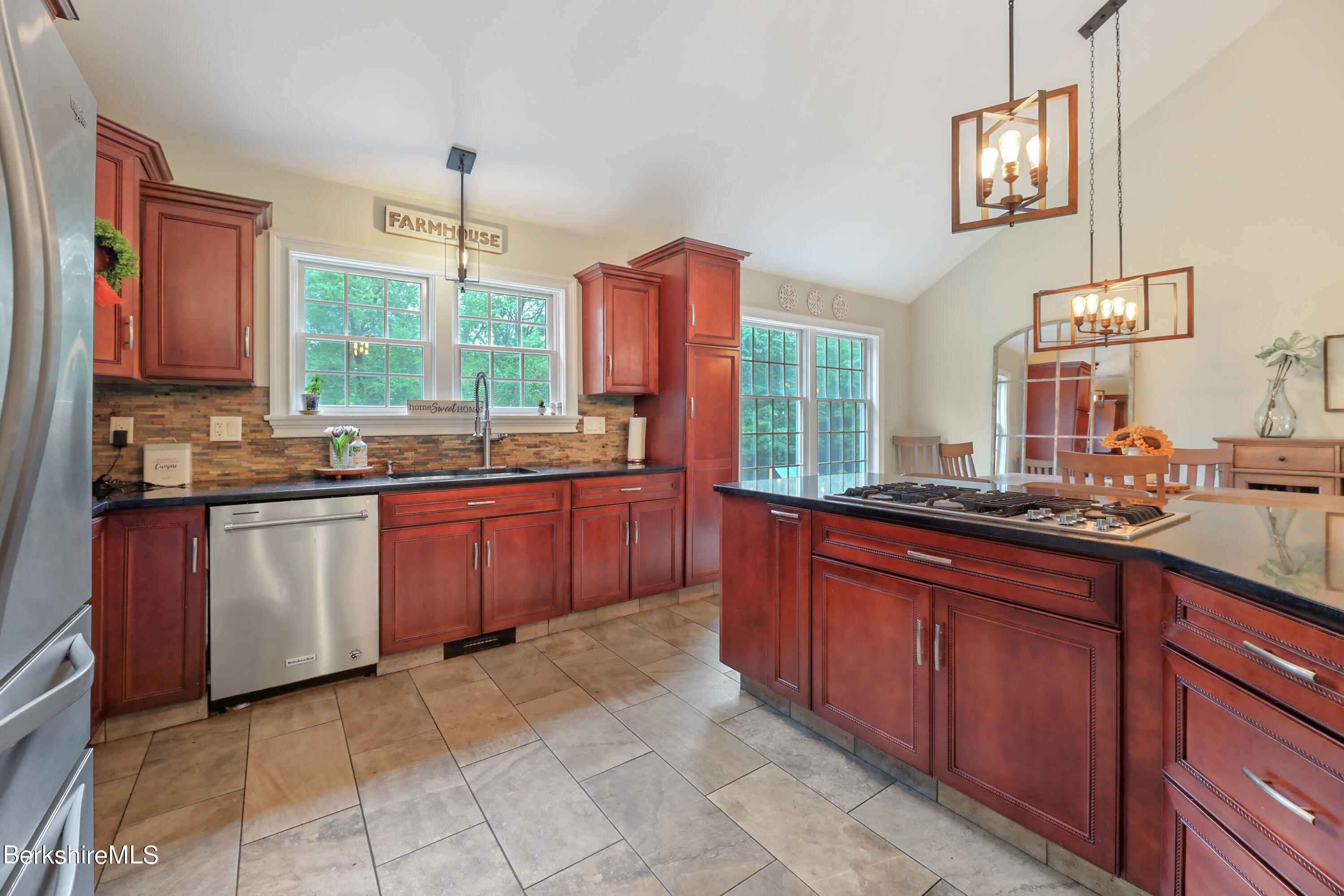 71 Goose Pond Road Tyringham, MA 01238 - Photo 9 of 43 a kitchen with stainless steel appliances granite countertop a stove a sink dishwasher and a microwave oven with cabinets