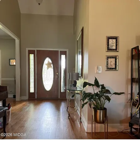 a living room with furniture and a mirror