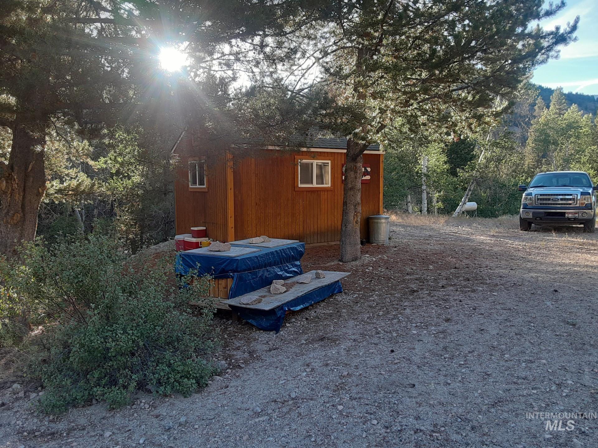 2074 Fleck Smt Road Fairfield, ID 83327 - Photo 2 of 22 View of outbuilding featuring a wooded view