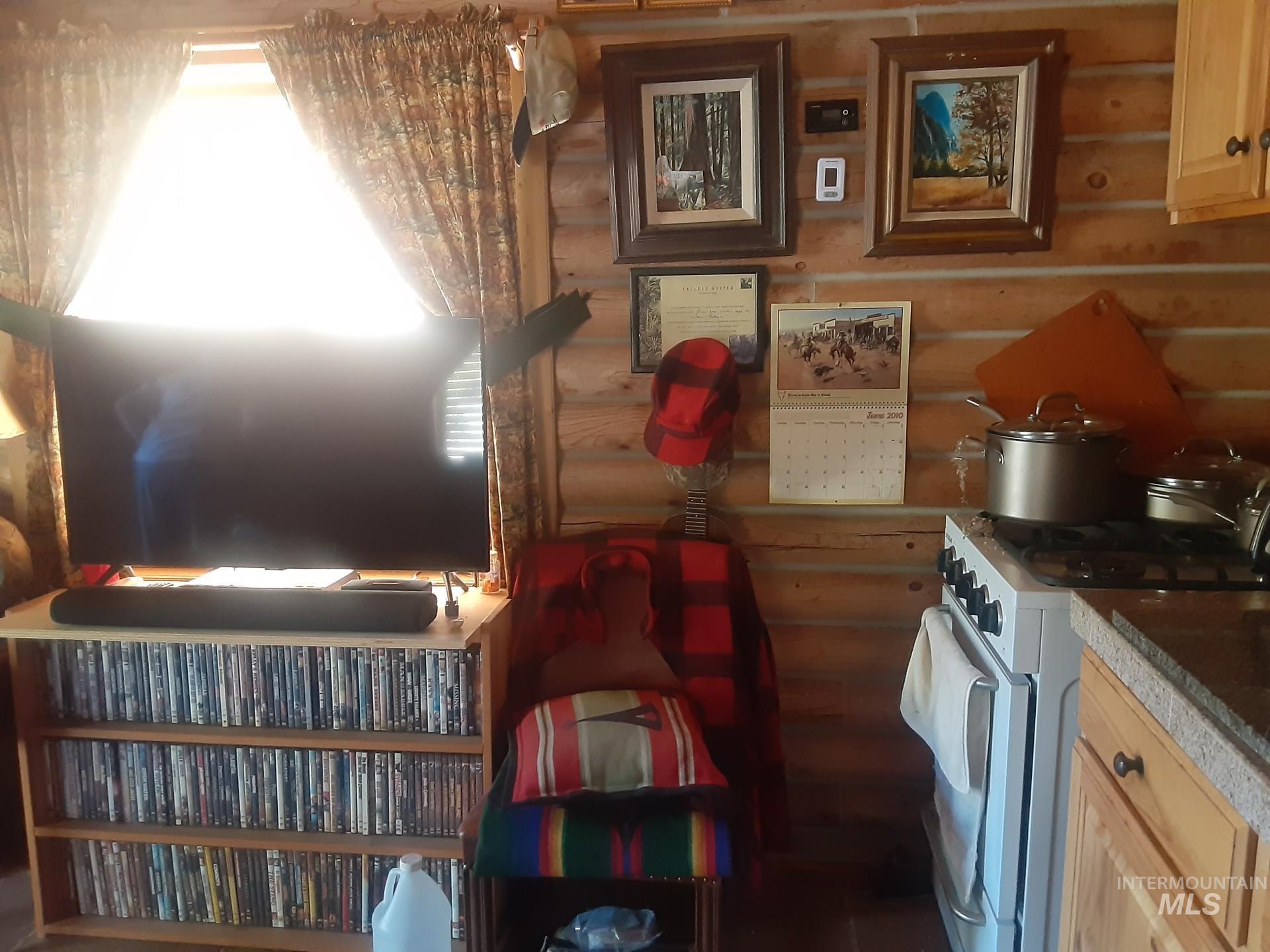 2074 Fleck Smt Road Fairfield, ID 83327 - Photo 5 of 22 Kitchen featuring gas range gas stove, log walls, and light brown cabinetry