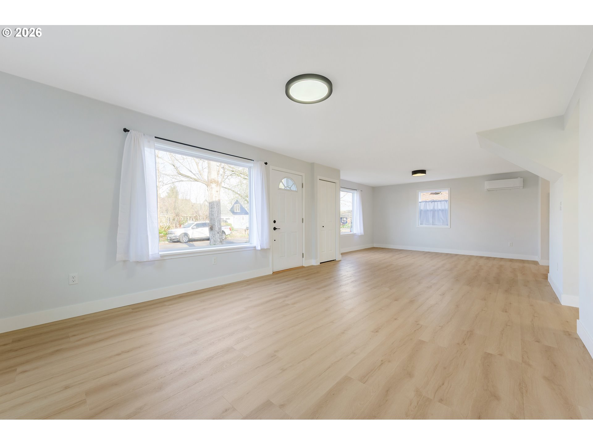 1243 Hayes Street Eugene, OR 97402 - Photo 11 of 48 a view of an empty room with wooden floor and windows
