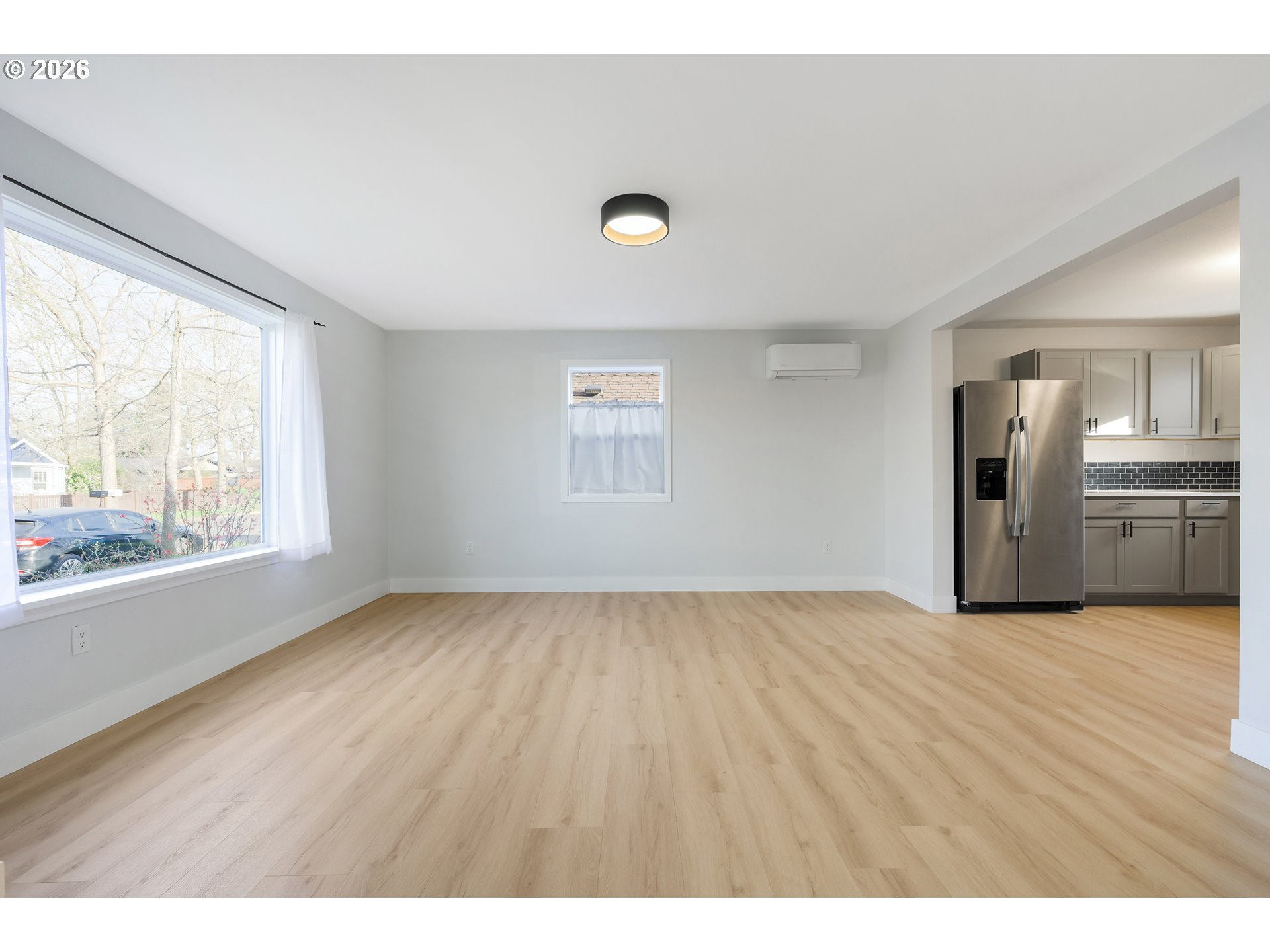1243 Hayes Street Eugene, OR 97402 - Photo 13 of 48 a view of an empty room with a window and wooden floor
