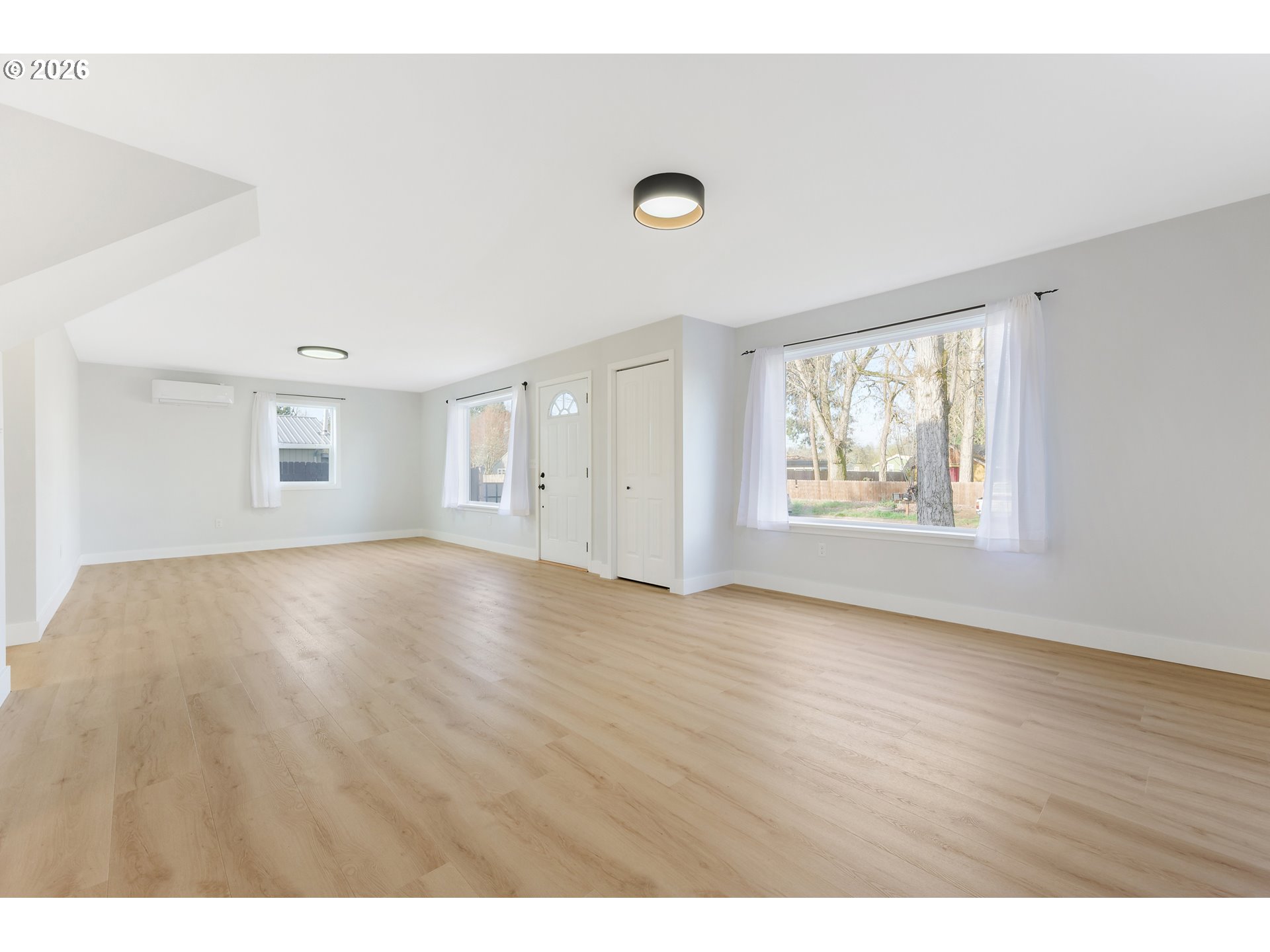 1243 Hayes Street Eugene, OR 97402 - Photo 15 of 48 a view of an empty room with wooden floor and a window