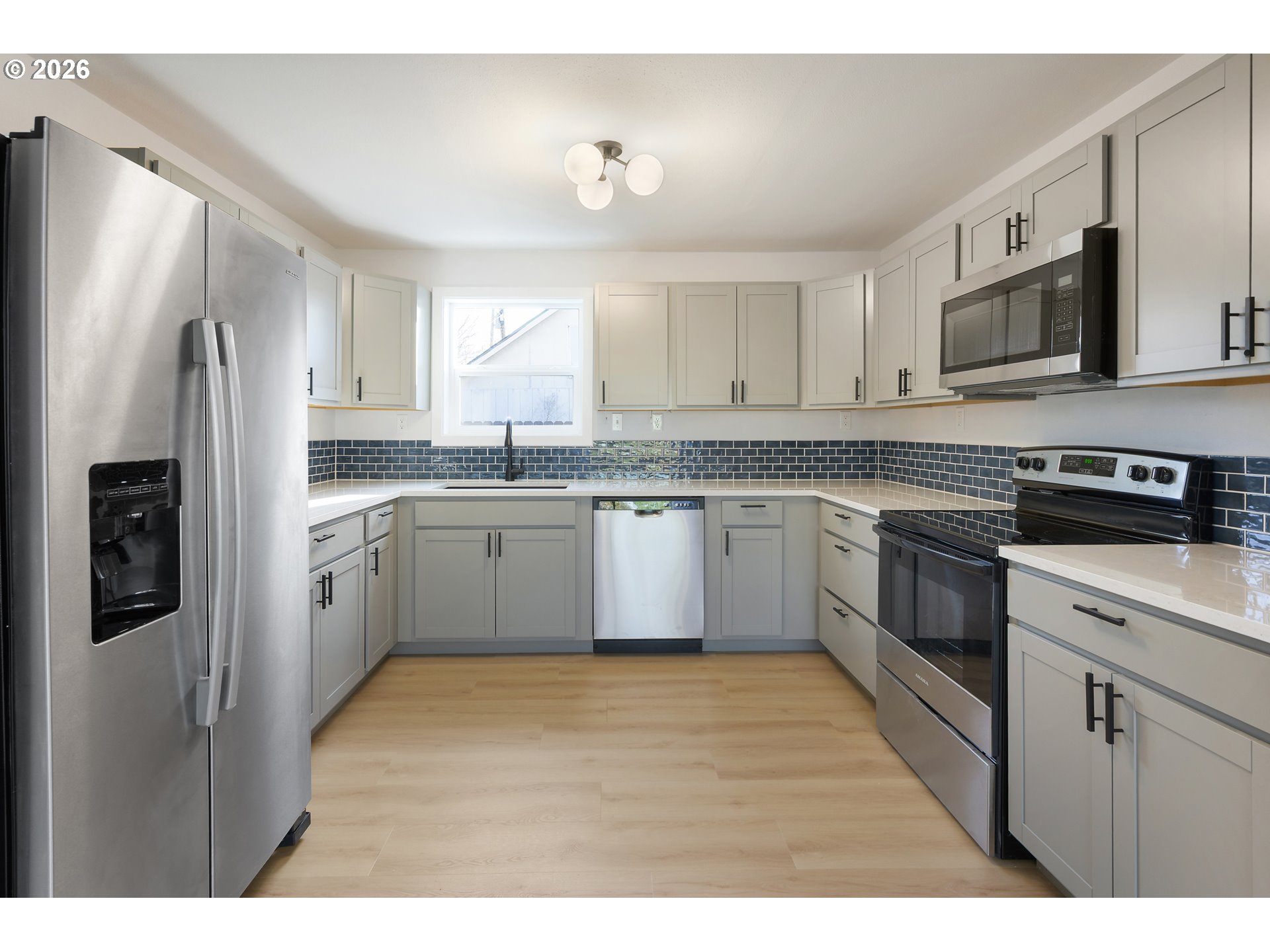 1243 Hayes Street Eugene, OR 97402 - Photo 18 of 48 a kitchen with stainless steel appliances granite countertop a stove a sink dishwasher a refrigerator and a microwave
