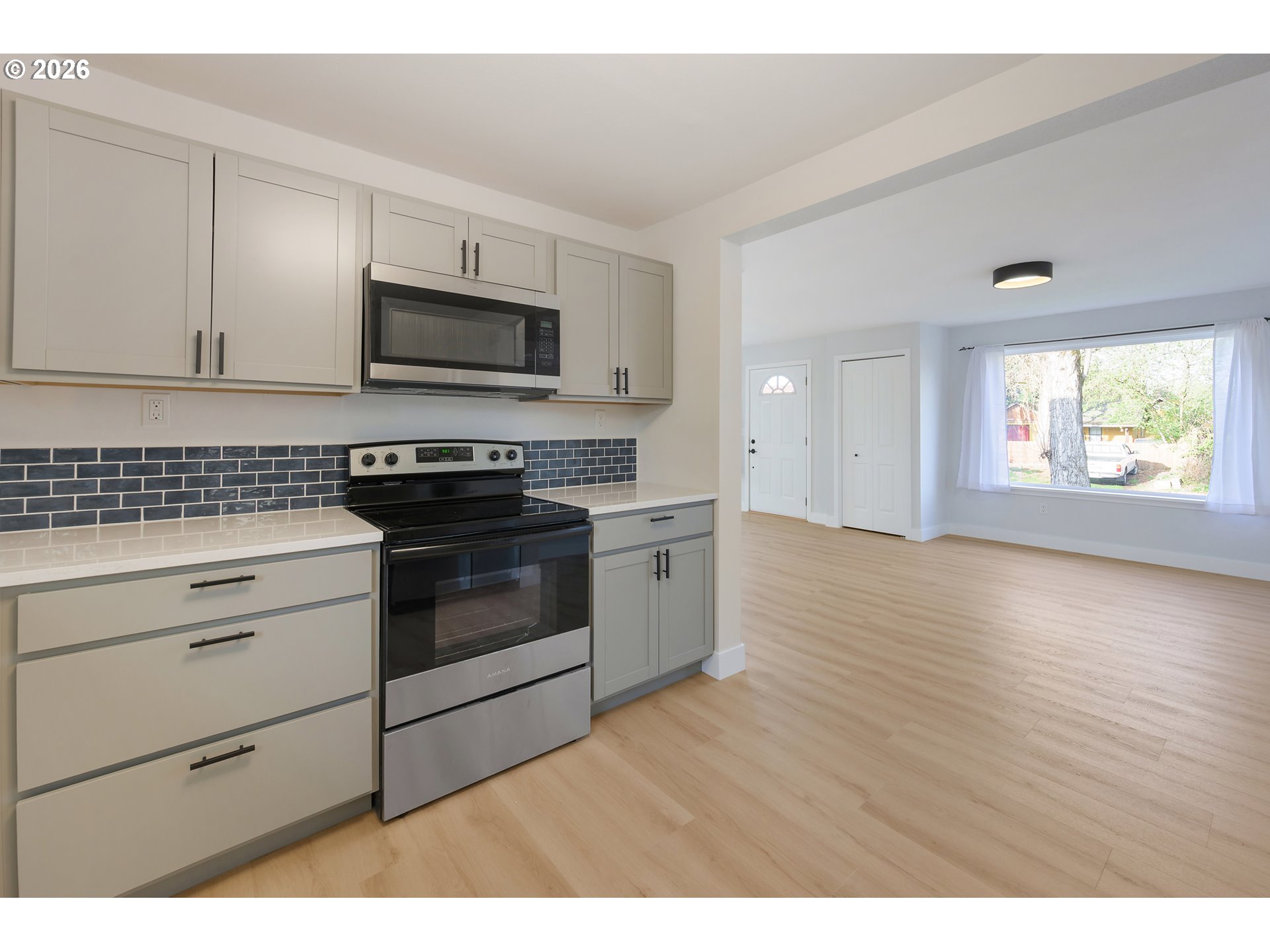 1243 Hayes Street Eugene, OR 97402 - Photo 21 of 48 a kitchen with stainless steel appliances granite countertop a stove a sink and a microwave