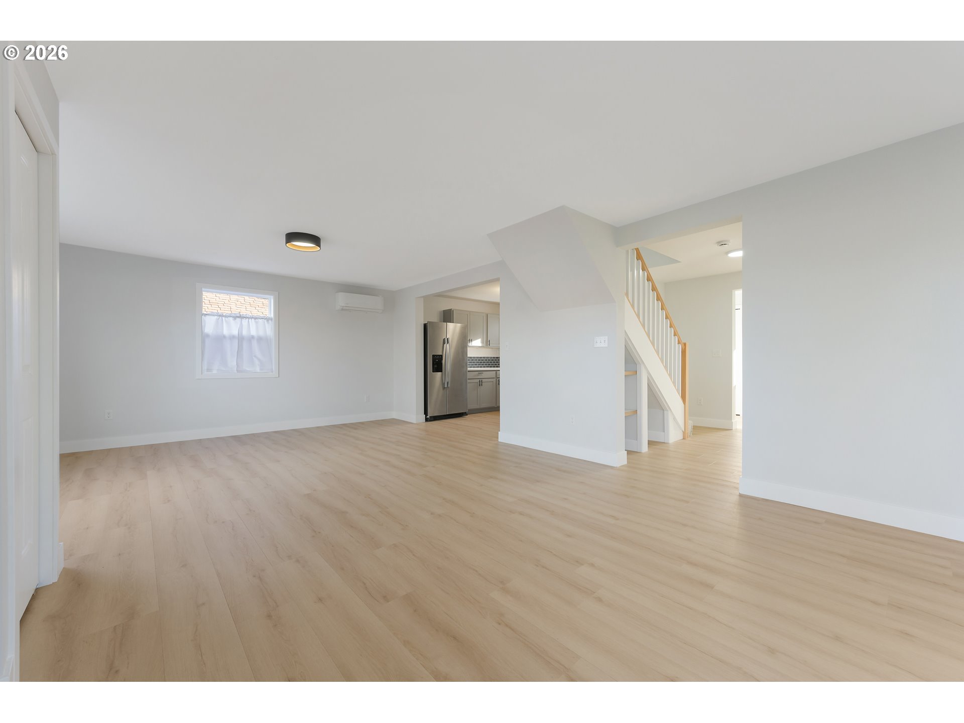 1243 Hayes Street Eugene, OR 97402 - Photo 5 of 48 a view of an empty room with wooden floor and a window