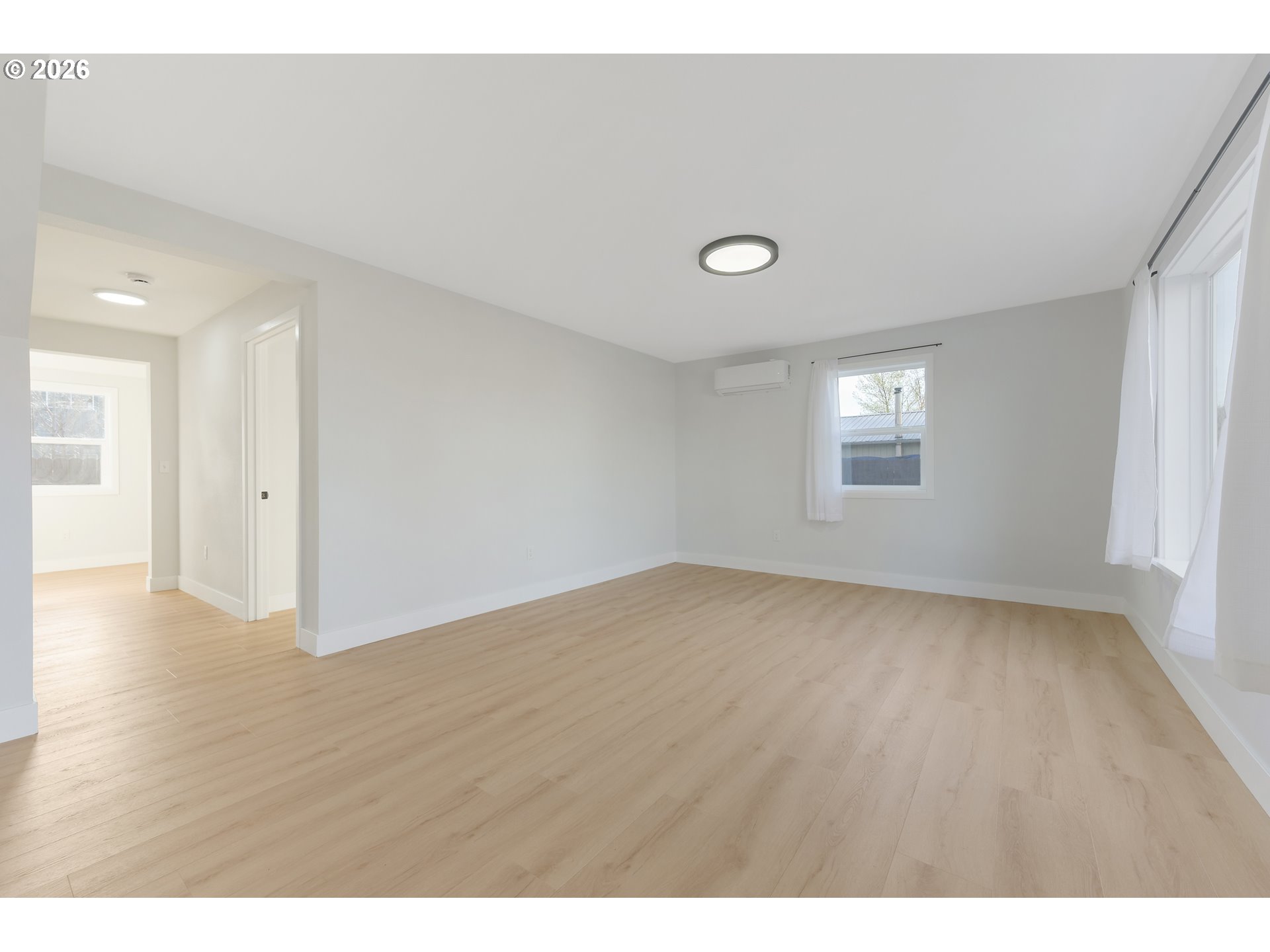 1243 Hayes Street Eugene, OR 97402 - Photo 7 of 48 a view of an empty room with wooden floor and a window