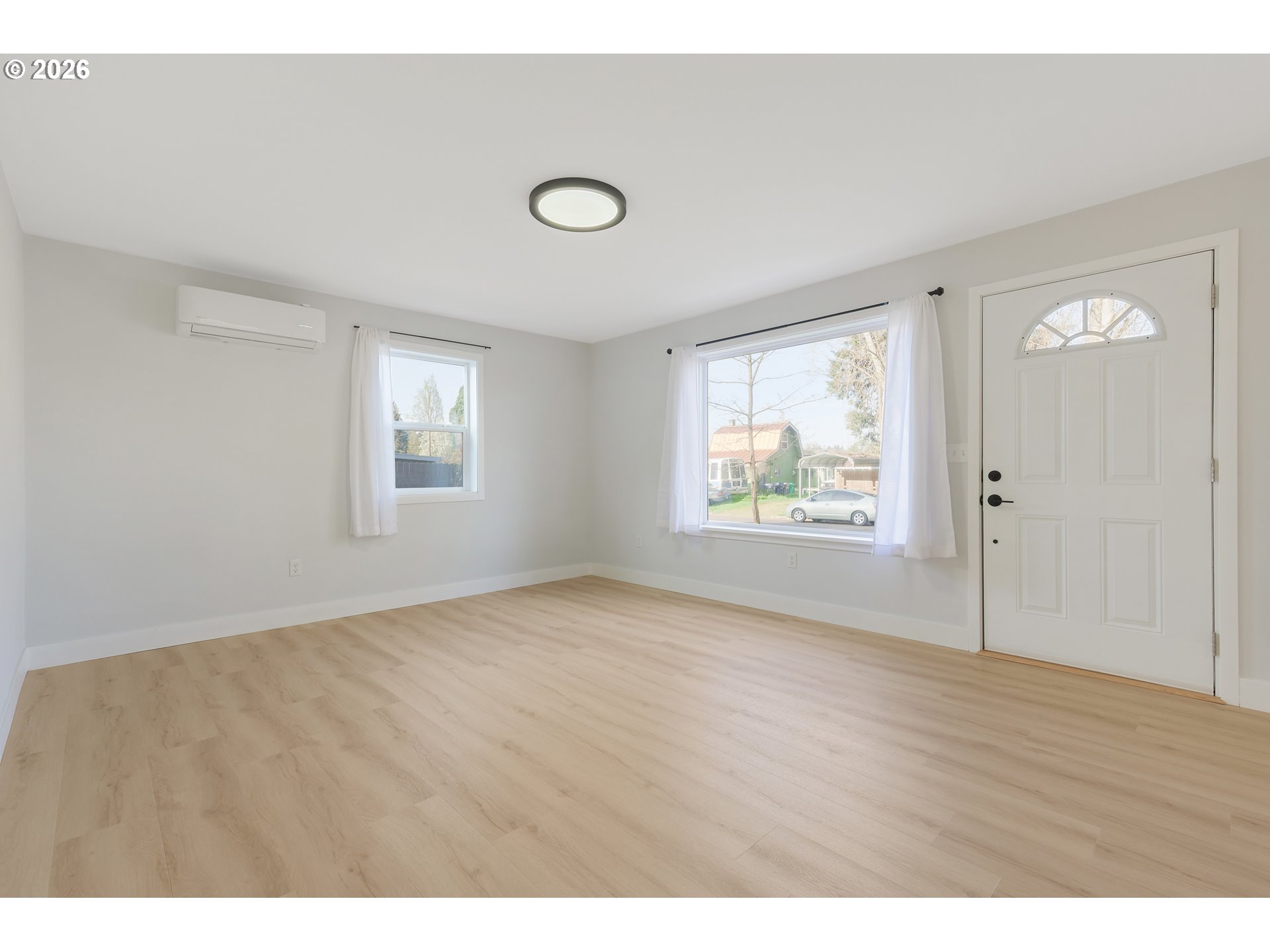 1243 Hayes Street Eugene, OR 97402 - Photo 9 of 48 a view of an empty room with wooden floor and a window