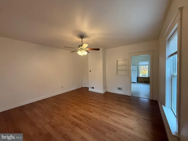 wooden floor in an empty room with a window