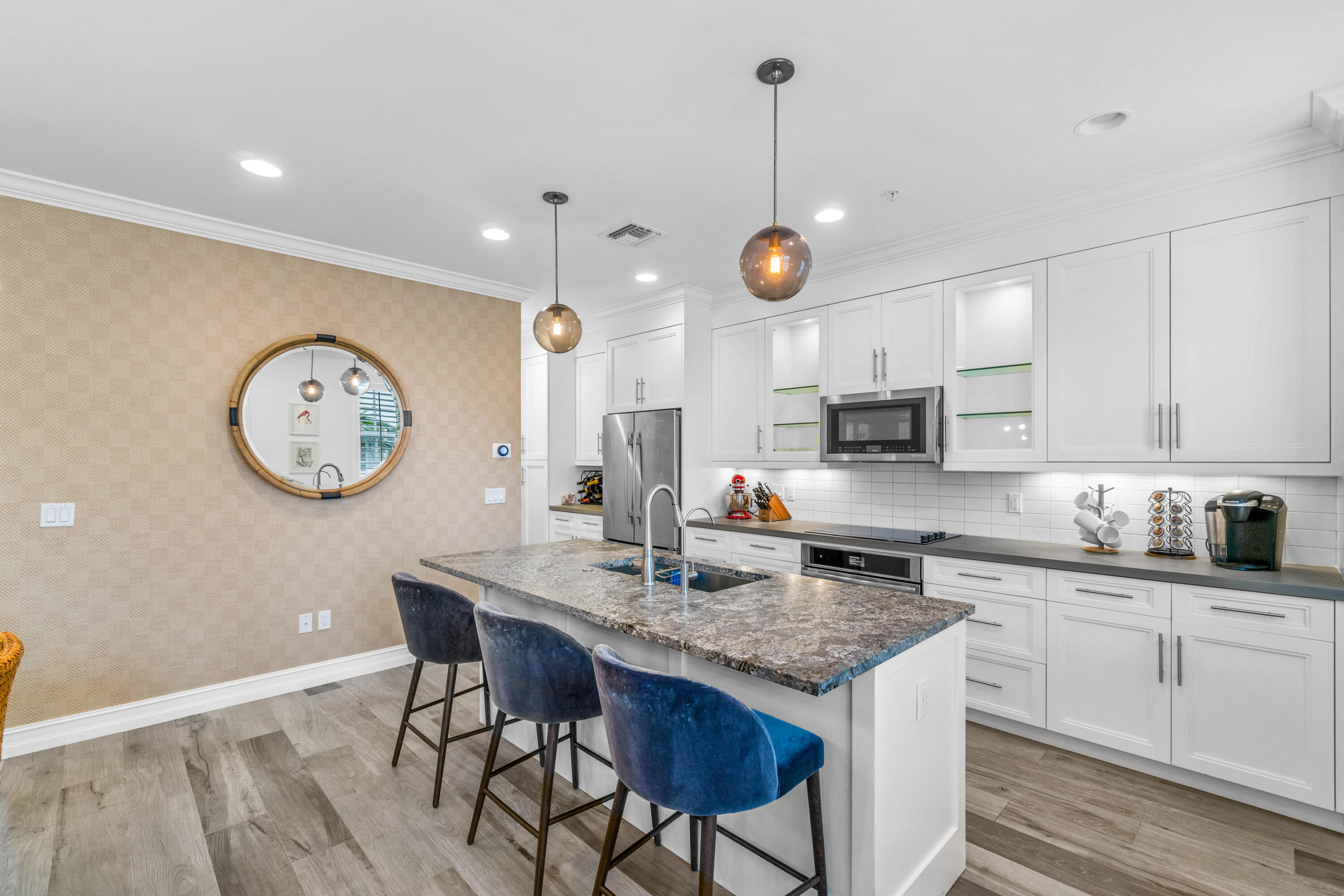 308 West Cannery Row Circle Delray Beach, FL 33444 - Photo 12 of 23 a very nice looking kitchen with granite countertop a stove a sink a dining table and chairs with wooden floor
