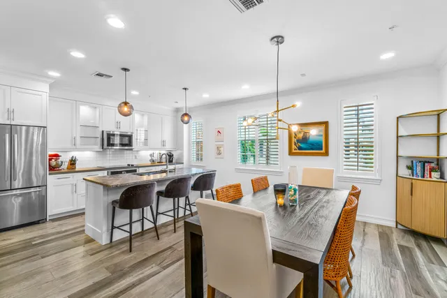 a kitchen with stainless steel appliances granite countertop a stove and a wooden floors