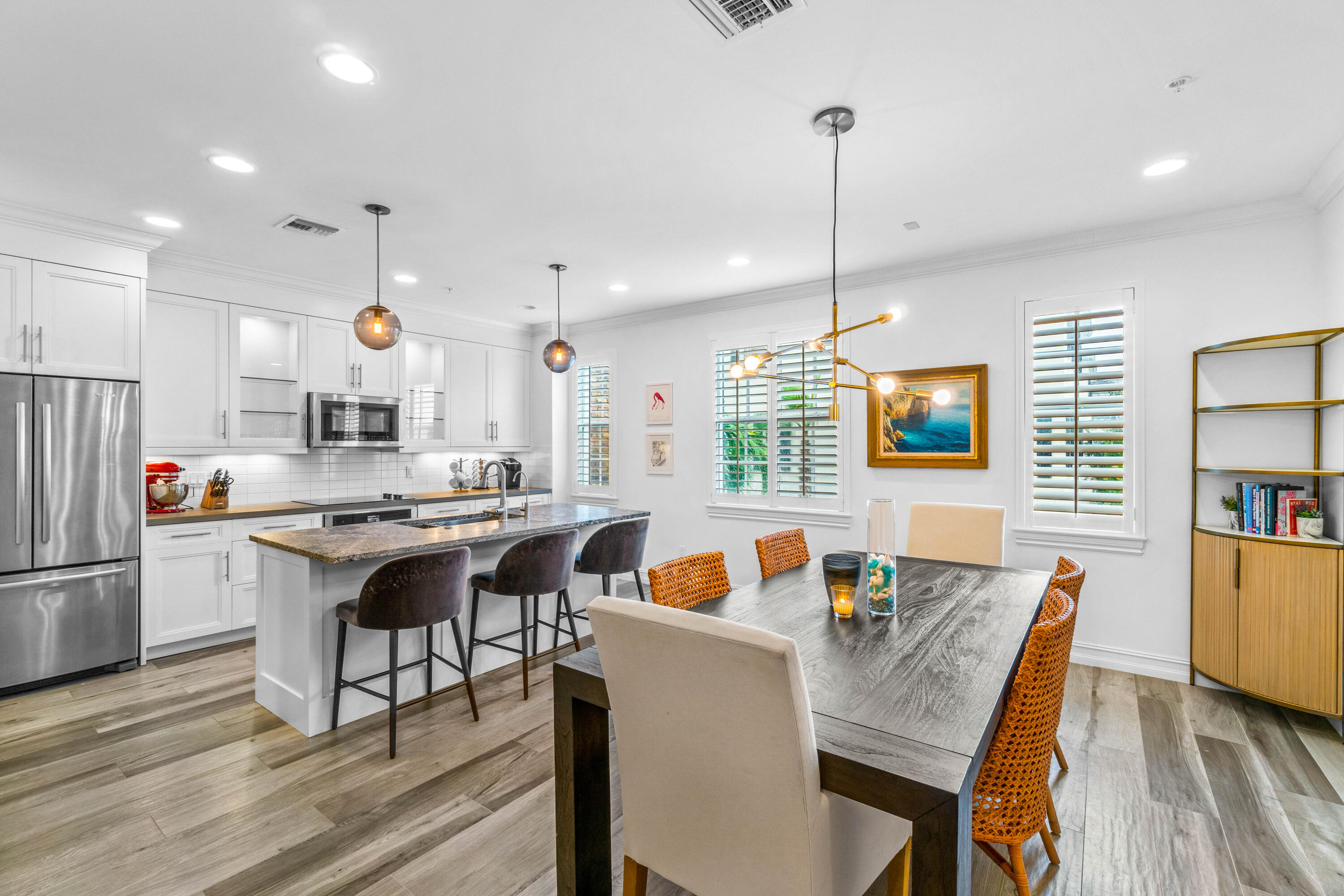 308 West Cannery Row Circle Delray Beach, FL 33444 - Photo 14 of 23 a kitchen with stainless steel appliances granite countertop a stove top oven a refrigerator a dining table and chairs with wooden floor
