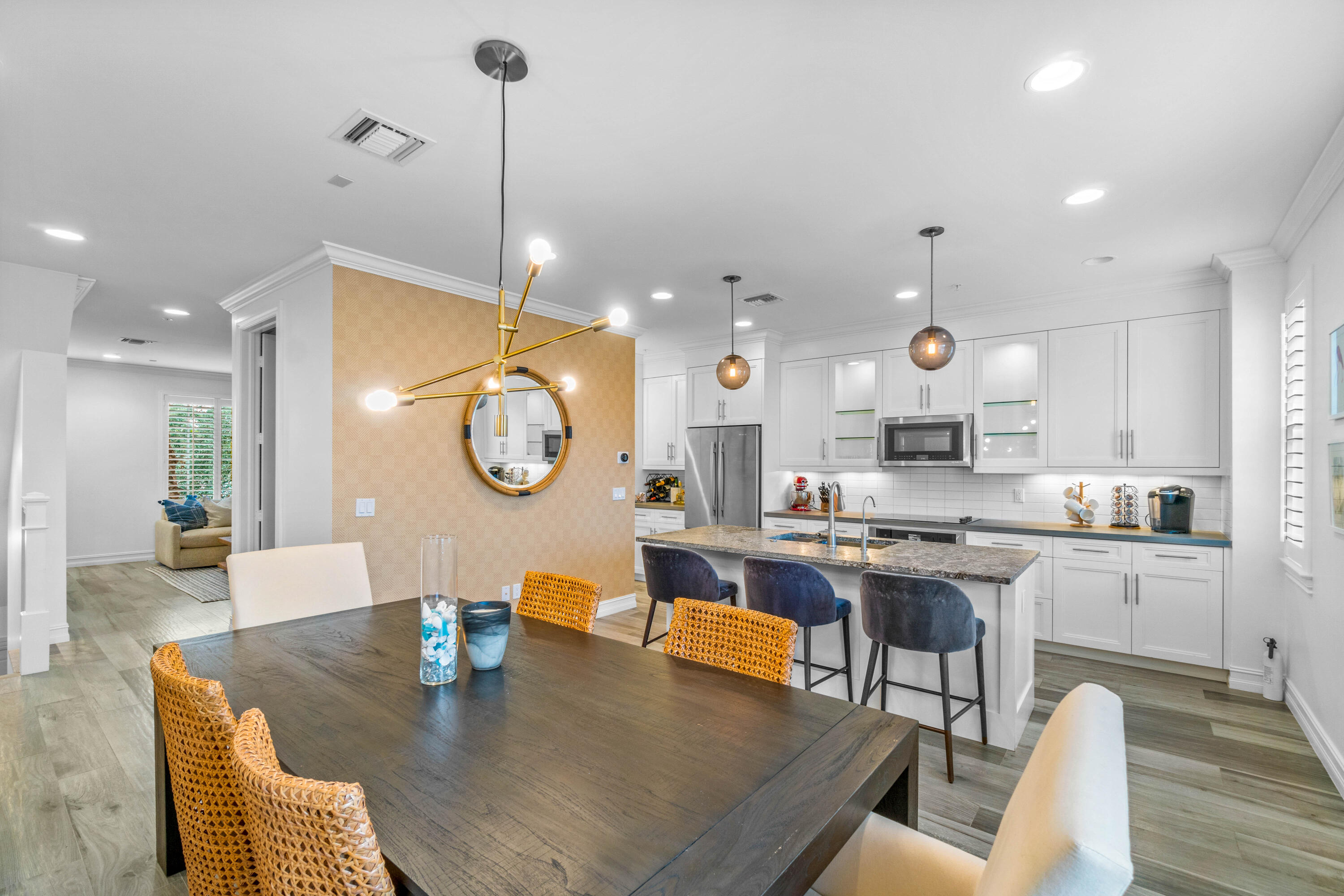 308 West Cannery Row Circle Delray Beach, FL 33444 - Photo 16 of 23 a large kitchen with kitchen island stainless steel appliances a table chairs sink and wooden floor