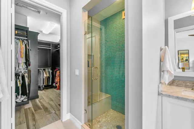 a view of walk in closet with clothes and shoes