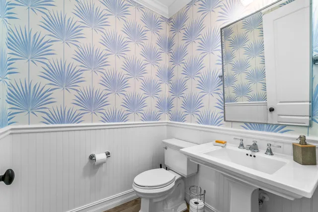 a bathroom with a sink a toilet and a mirror