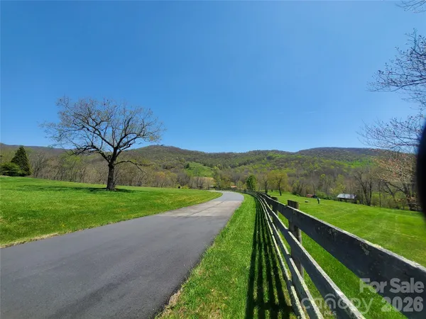 a view of a terrace with yard and mountain view in back