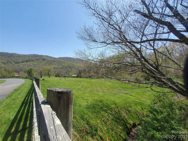 a view of a terrace with yard and mountain view in back