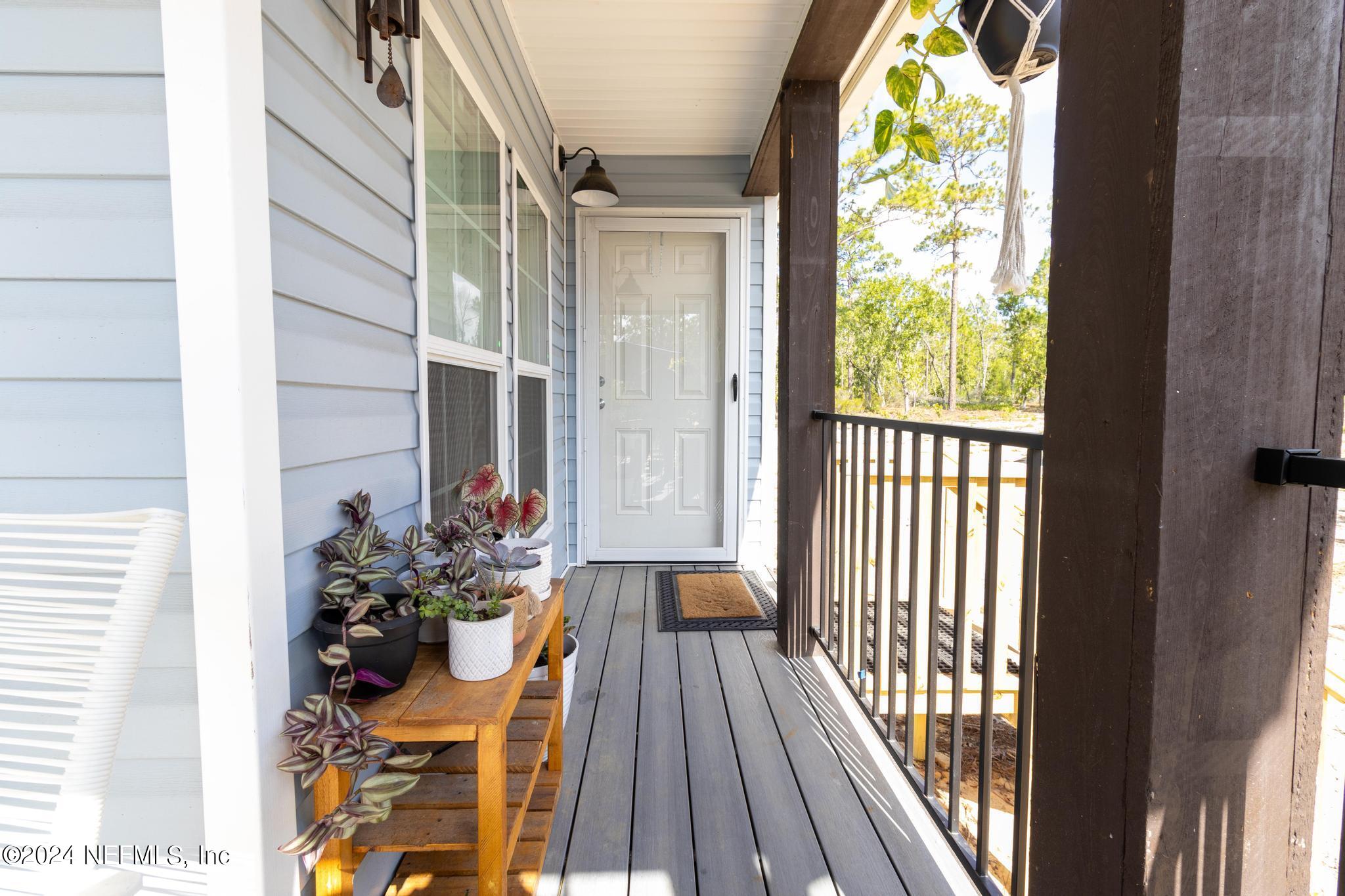 121 Honeysuckle Trail Hawthorne, FL 32640 - Photo 12 of 44 a view of a balcony with wooden floor