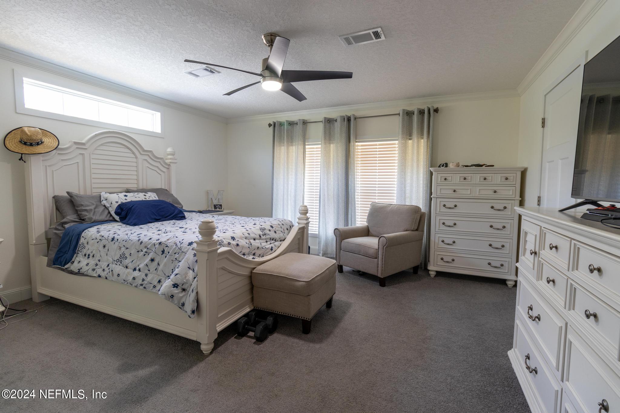 121 Honeysuckle Trail Hawthorne, FL 32640 - Photo 13 of 44 a spacious bedroom with a bed and a couch