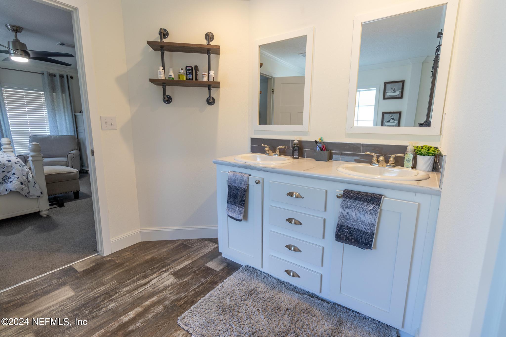 121 Honeysuckle Trail Hawthorne, FL 32640 - Photo 15 of 44 a bathroom with a sink and a mirror